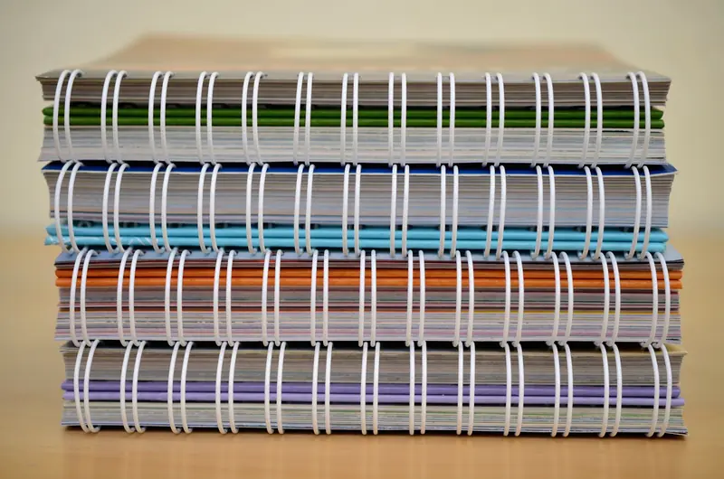 Cuadernos espiralados apilados, con anillado de colores